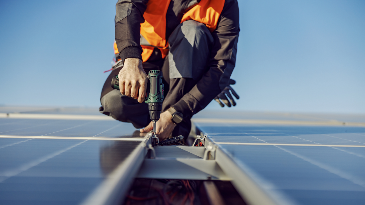 Close up of a Solar Panel Contractor installing solar panels on roof
